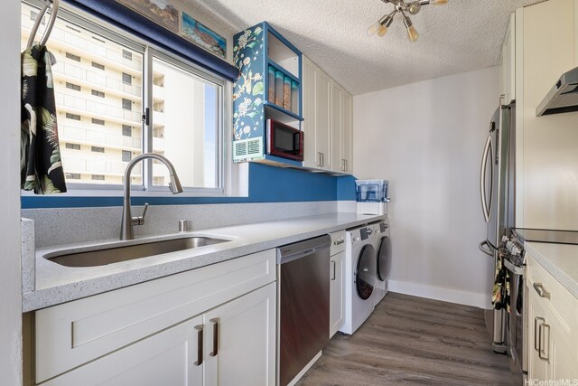 1111 Wilder Ave Unit 14B, Honolulu, HI 96822 - kitchen with stainless steel appliances, independent washer and dryer, light countertops, white cabinetry, and a textured ceiling