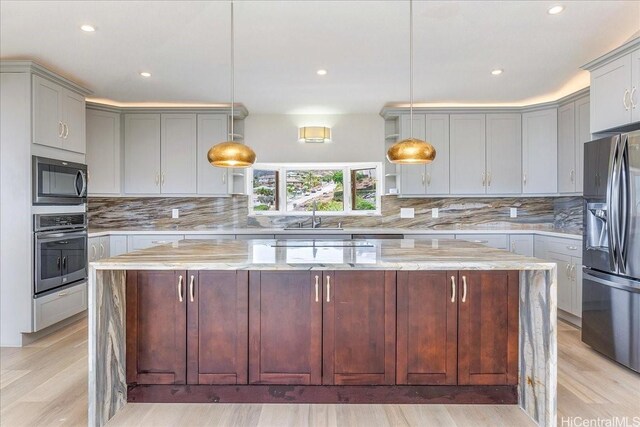 1062 Hoa St, Honolulu, HI 96825 - kitchen featuring appliances with stainless steel finishes, a sink, a kitchen island, open shelves, and decorative backsplash