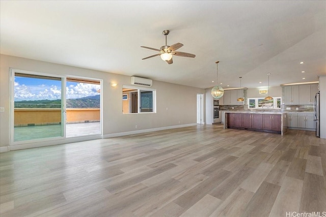 1062 Hoa St, Honolulu, HI 96825 - unfurnished living room with an AC wall unit, recessed lighting, a ceiling fan, light wood finished floors, and baseboards
