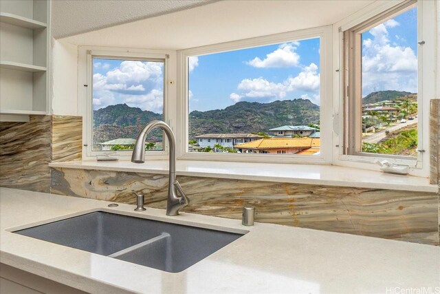 1062 Hoa St, Honolulu, HI 96825 - kitchen view of a sink, mountains, and backsplash