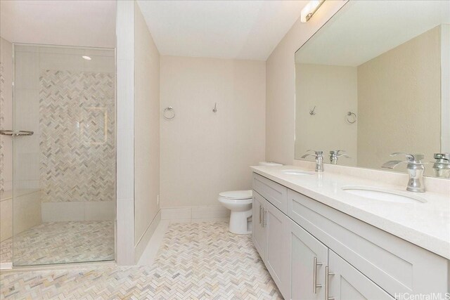 1062 Hoa St, Honolulu, HI 96825 - bathroom featuring double vanity, tiled shower, toilet, tile patterned flooring, and baseboards