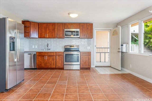1062 Hoa St, Honolulu, HI 96825 - kitchen featuring stainless steel appliances, open shelves, and brown cabinets