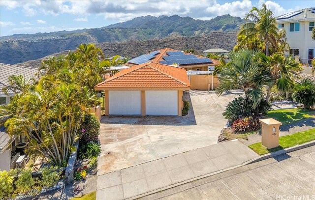 1062 Hoa St, Honolulu, HI 96825 - view of front of property featuring a tiled roof, a mountain view, stucco siding, and a gate