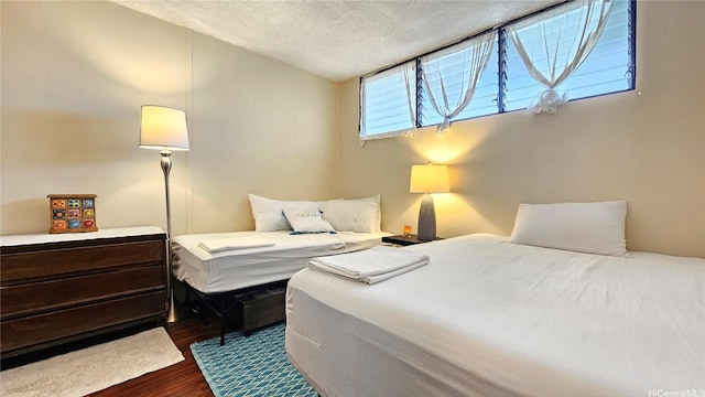 2121 Ala Wai Blvd Unit 1603, Honolulu, HI 96815 - bedroom with dark wood-style flooring and a textured ceiling