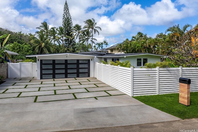 114 Kaelepulu Dr, Kailua, HI 96734 - view of front facade with concrete driveway and an attached garage