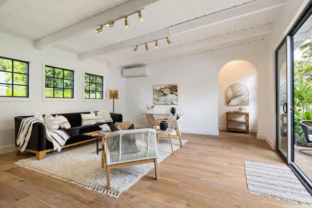 114 Kaelepulu Dr, Kailua, HI 96734 - living room featuring a wall mounted AC, arched walkways, healthy amount of natural light, baseboards, and wood ceiling with exposed beams