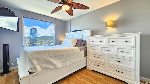 1717 Ala Wai Blvd Unit 2002, Honolulu, HI 96815 - bedroom featuring light wood finished floors, ceiling fan, and baseboards
