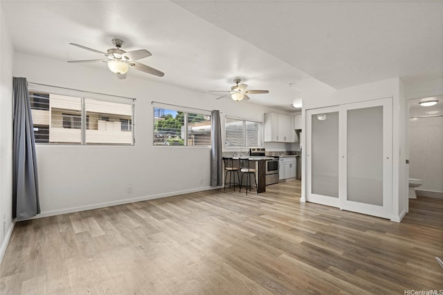 1447 Kewalo St Unit 101, Honolulu, HI 96822 - living room with a ceiling fan, wood finished floors, and baseboards