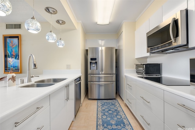 583 Kamoku St Unit Dh2303, Honolulu, HI 96826 - kitchen with stainless steel appliances, light countertops, white cabinetry, hanging light fixtures, and crown molding