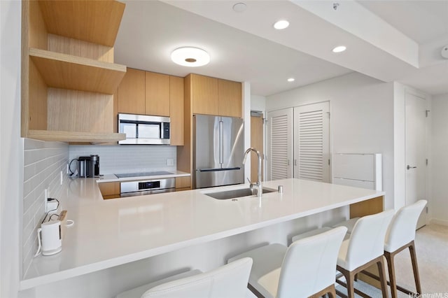 1388 Kapiolani Blvd Unit 3701, Honolulu, HI 96814 - kitchen featuring stainless steel appliances, tasteful backsplash, a kitchen breakfast bar, a peninsula, and recessed lighting