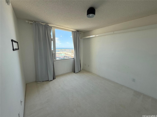 215 N King St Unit 2205, Honolulu, HI 96817 - unfurnished room featuring a textured ceiling and light colored carpet