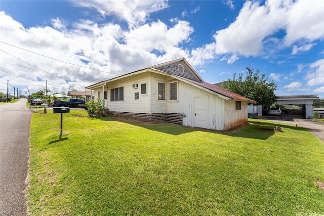 1305 Manua St, Wahiawa, HI 96786 - view of side of property featuring asphalt driveway and a lawn