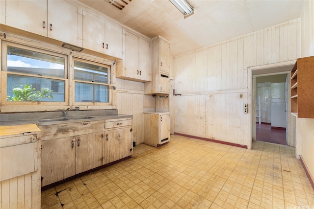 1305 Manua St, Wahiawa, HI 96786 - kitchen with light floors, wood walls, and light countertops