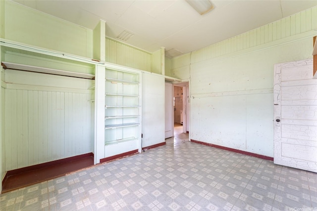 1305 Manua St, Wahiawa, HI 96786 - unfurnished bedroom featuring a closet, tile patterned floors, and wooden walls