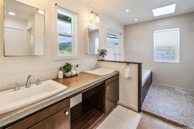 1226 Kahili St, Kailua, HI 96734 - full bath featuring double vanity, a skylight, a bath, recessed lighting, and decorative backsplash