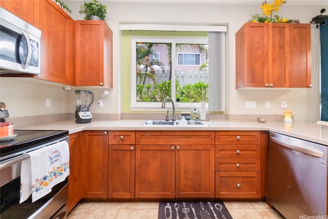 91-1152 Paapaana St, Ewa Beach, HI 96706 - kitchen with stainless steel appliances, light countertops, light tile patterned floors, and brown cabinets