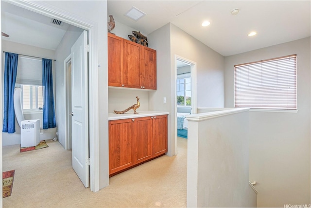 91-1152 Paapaana St, Ewa Beach, HI 96706 - kitchen with light carpet, light countertops, recessed lighting, and brown cabinets