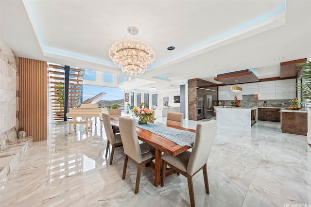 123 Waihili Pl, Honolulu, HI 96825 - dining area with a chandelier, a tray ceiling, and light marble finish flooring