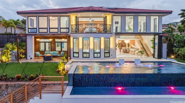 123 Waihili Pl, Honolulu, HI 96825 - back of house featuring outdoor lounge area, a balcony, a patio area, and a pool with connected hot tub