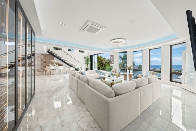 123 Waihili Pl, Honolulu, HI 96825 - living area with light marble finish floors, stairway, a raised ceiling, and a water view