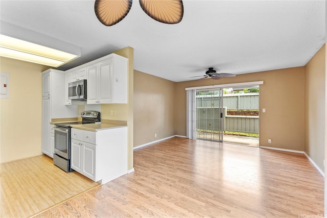 94-1336 Kulewa Loop Unit 5D, Waipahu, HI 96797 - kitchen featuring appliances with stainless steel finishes, light wood-style flooring, light countertops, white cabinets, and a ceiling fan