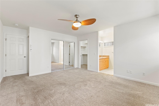 1410 Alapai St Unit 5, Honolulu, HI 96813 - unfurnished bedroom featuring light colored carpet, baseboards, connected bathroom, a ceiling fan, and a sink