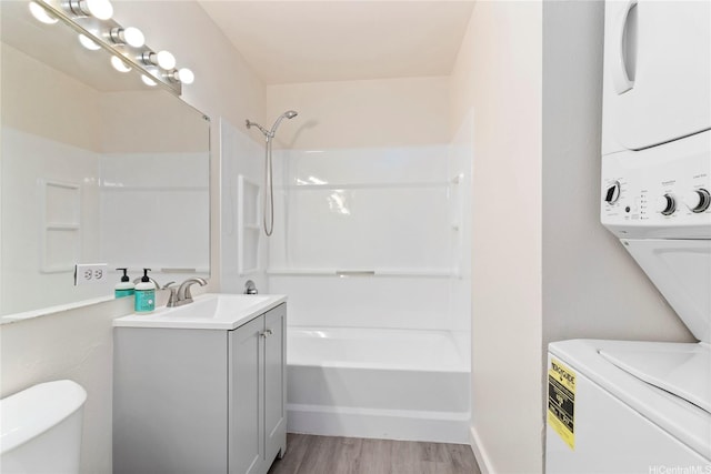 91-225 Hanapouli Cir Unit 33F, Ewa Beach, HI 96706 - full bathroom with estacked washer and dryer, vanity, wood finished floors, and shower / washtub combination