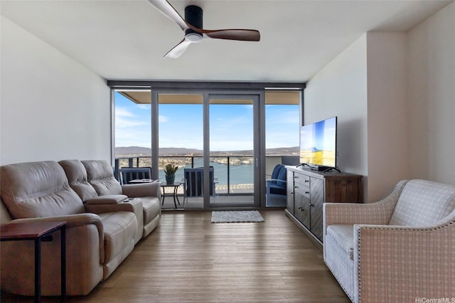 600 Ala Moana Blvd Unit 3006, Honolulu, HI 96813 - living area with floor to ceiling windows, wood finished floors, and ceiling fan