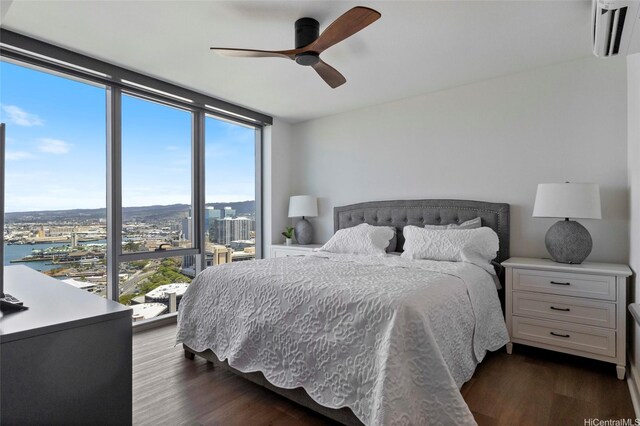 600 Ala Moana Blvd Unit 3006, Honolulu, HI 96813 - bedroom featuring dark wood-style floors, floor to ceiling windows, a wall mounted AC, a ceiling fan, and a city view