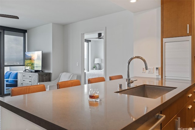 600 Ala Moana Blvd Unit 3006, Honolulu, HI 96813 - kitchen with a sink, brown cabinetry, open floor plan, and recessed lighting