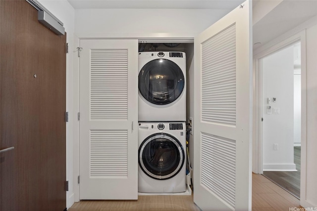 600 Ala Moana Blvd Unit 3006, Honolulu, HI 96813 - laundry room with stacked washer / drying machine, wood finished floors, and baseboards