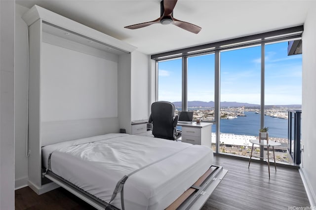 600 Ala Moana Blvd Unit 3006, Honolulu, HI 96813 - bedroom featuring expansive windows, a water and mountain view, dark wood-style floors, an office area, and a ceiling fan
