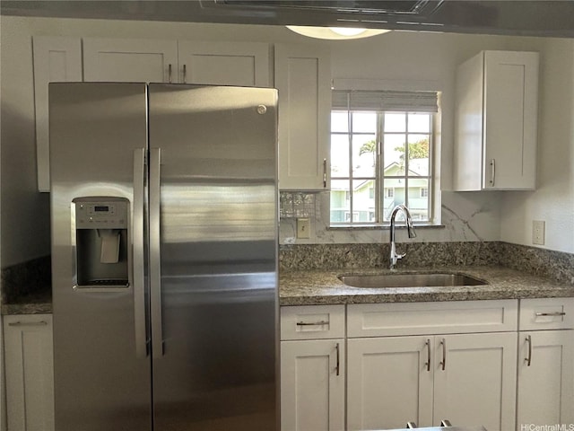 941449 Waipio Uka St Unit K204, Waipahu, HI 96797 - kitchen featuring stainless steel fridge with ice dispenser, a sink, white cabinetry, and dark stone countertops