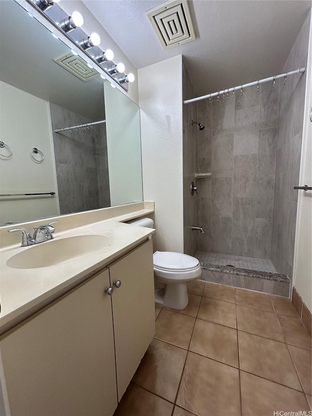 941449 Waipio Uka St Unit K204, Waipahu, HI 96797 - bathroom featuring toilet, vanity, a tile shower, and tile patterned floors
