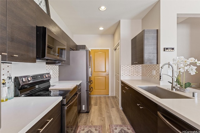 91-1159 Kamakana St Unit 818, Ewa Beach, HI 96706 - kitchen with stainless steel appliances, light countertops, light wood-style floors, decorative backsplash, and recessed lighting