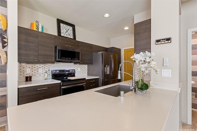 91-1159 Kamakana St Unit 818, Ewa Beach, HI 96706 - kitchen with appliances with stainless steel finishes, dark brown cabinetry, light countertops, backsplash, and recessed lighting