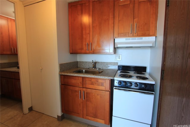 2888 Ala Ilima St Unit 2610, Honolulu, HI 96818 - kitchen with electric range, under cabinet range hood, light tile patterned flooring, light stone countertops, and brown cabinetry