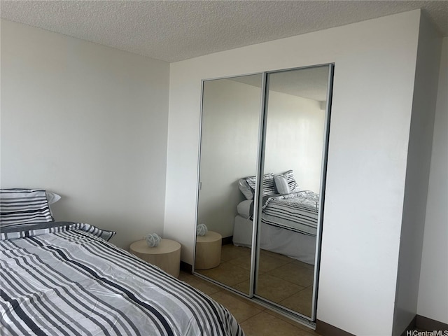 2888 Ala Ilima St Unit 2610, Honolulu, HI 96818 - bedroom with tile patterned flooring, a closet, and a textured ceiling