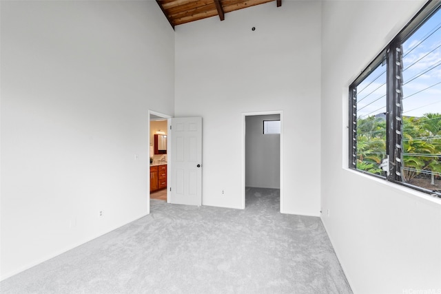 44-279 Kaneohe Bay Dr Unit B, Kaneohe, HI 96744 - unfurnished bedroom with light colored carpet, wooden ceiling with exposed beams, high vaulted ceiling, a walk in closet, and ensuite bath
