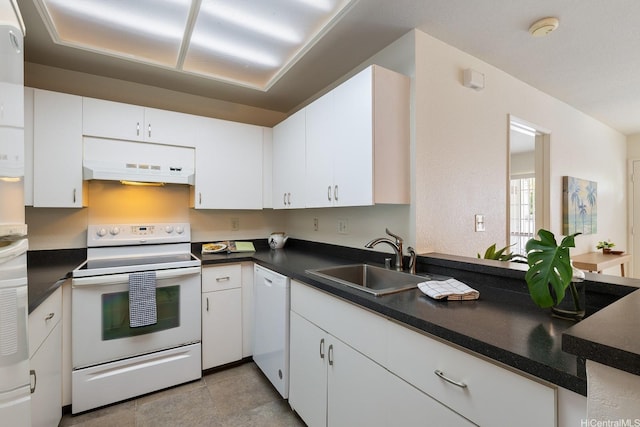 492 Mananai Pl Unit 13E, Honolulu, HI 96818 - kitchen with white appliances, premium range hood, a sink, and dark countertops