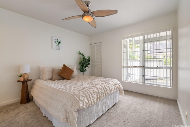 492 Mananai Pl Unit 13E, Honolulu, HI 96818 - bedroom featuring light colored carpet, baseboards, a ceiling fan, and a closet