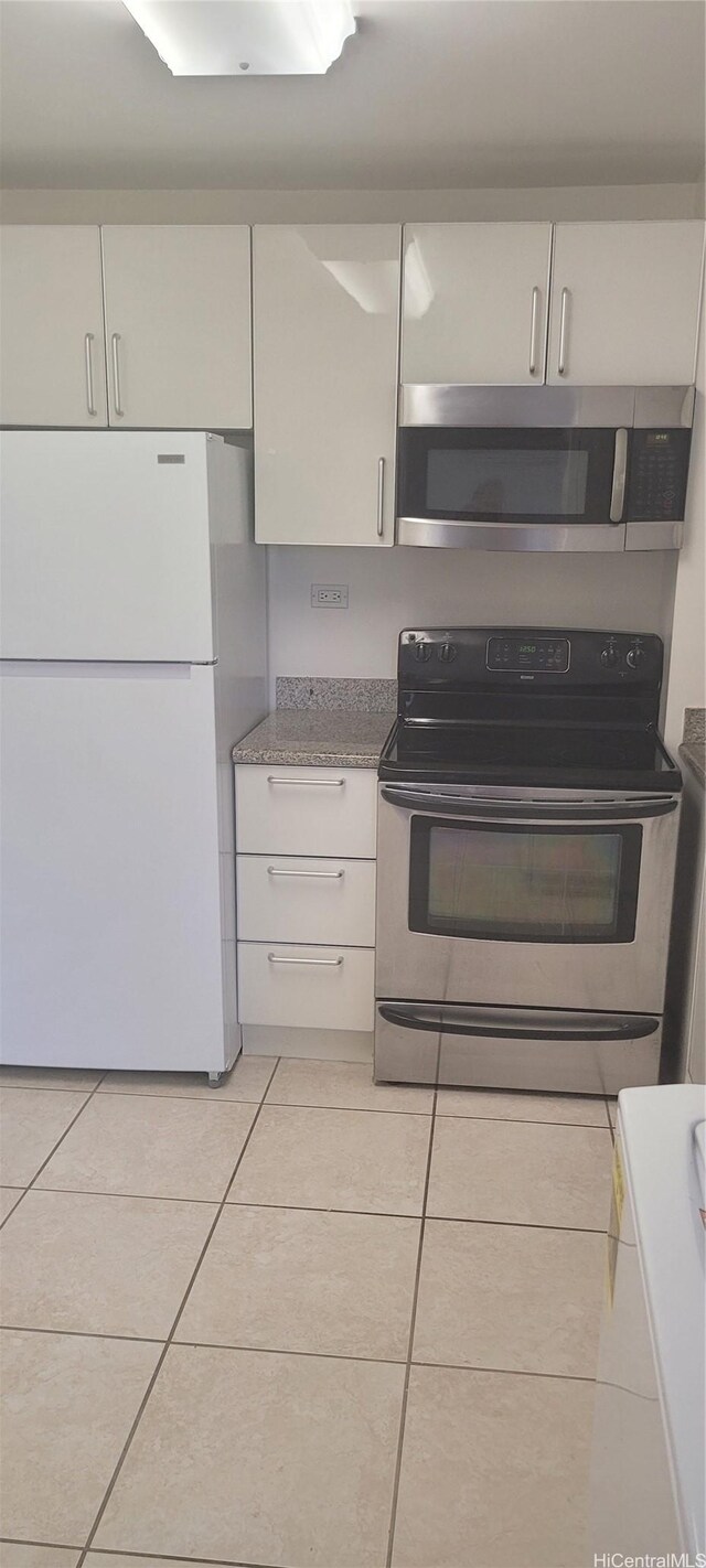 1402 Piikoi St Unit 502, Honolulu, HI 96822 - kitchen with appliances with stainless steel finishes and light tile patterned floors