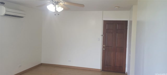 1402 Piikoi St Unit 502, Honolulu, HI 96822 - empty room featuring a wall mounted AC, ceiling fan, light wood-type flooring, baseboards, and a smoke detector