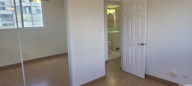 1402 Piikoi St Unit 502, Honolulu, HI 96822 - hallway featuring a sink, light wood finished floors, and baseboards