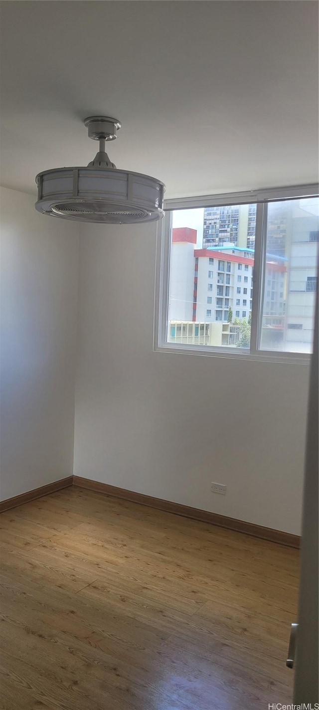 1402 Piikoi St Unit 502, Honolulu, HI 96822 - spare room with wood finished floors and baseboards