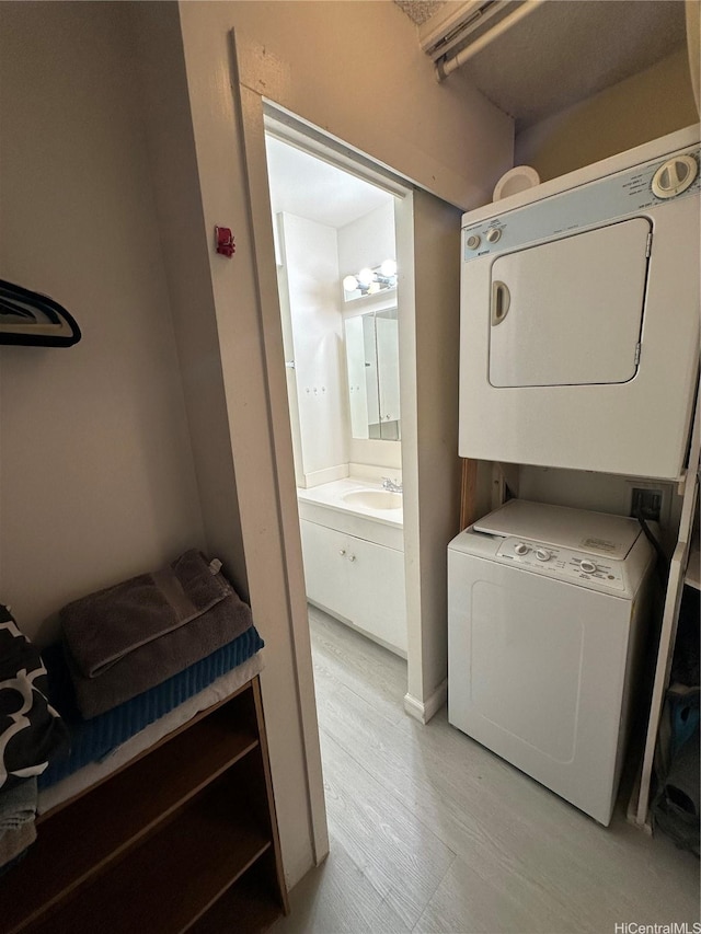 2345 Ala Wai Blvd Unit 2209, Honolulu, HI 96815 - laundry area with stacked washer and clothes dryer and light wood-type flooring