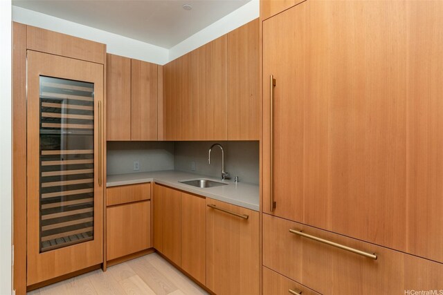 1100 Ala Moana Blvd Unit 4000/4001, Honolulu, HI 96814 - kitchen with a sink, light countertops, beverage cooler, modern cabinets, and light wood-style flooring