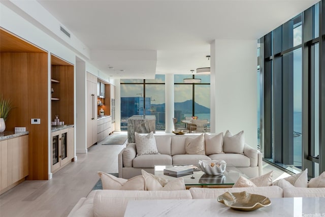 1100 Ala Moana Blvd Unit 4000/4001, Honolulu, HI 96814 - living area with light wood-style floors and a wall of windows