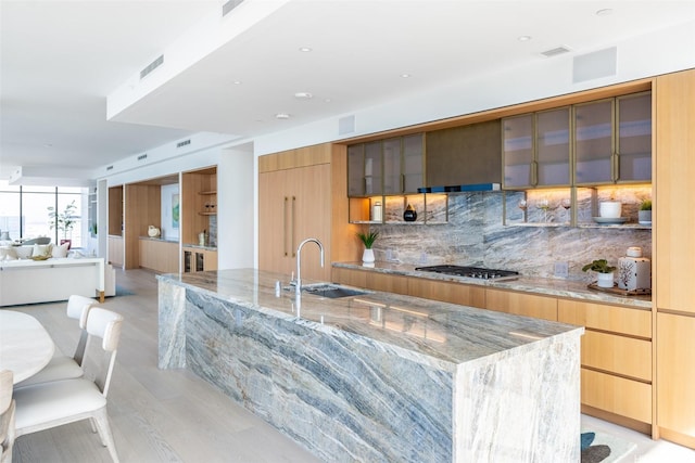 1100 Ala Moana Blvd Unit 4000/4001, Honolulu, HI 96814 - kitchen with modern cabinets, a sink, stainless steel gas cooktop, and light stone countertops