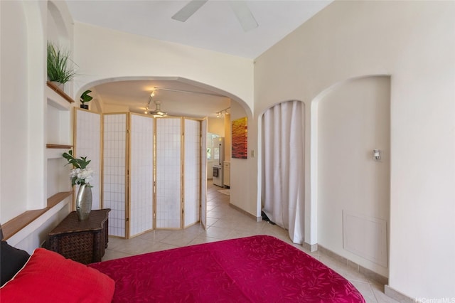 1020 Green St Unit 303, Honolulu, HI 96822 - bedroom with arched walkways, tile patterned flooring, and a ceiling fan